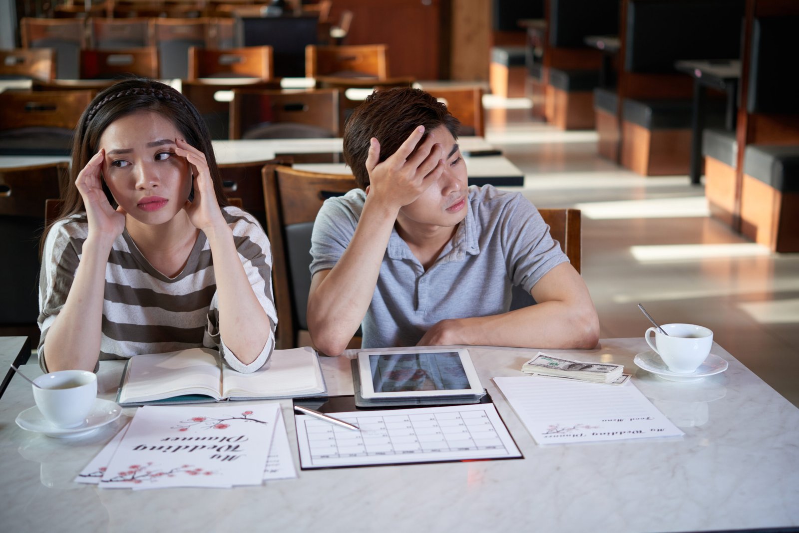 Couple feeling overwhelmed while planning their wedding